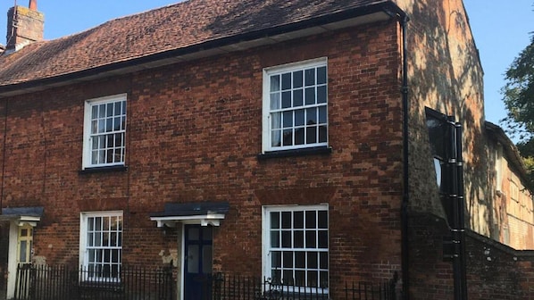 Arrive at the historic red brick facade of The Old Barn, Marlborough