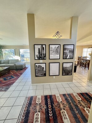 The home's open floor plan seamlessly connects the kitchen, living room, and dining room, creating a spacious and airy feel perfect for entertaining and spending time together.
