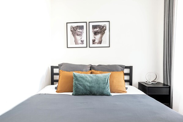 Large, comfy queen bed with plenty of pillows and extra blankets