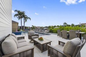 The outdoor area of this villa features a stunning heated pool with an attached spa, perfect for unwinding and enjoying the beautiful Florida weather.