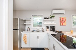 Cook in your fully stocked kitchen which includes pots, pans, and other essentials.  Please note there's no oven, but you have an air frying toaster oven (not pictured) to the right of the fridge which fits a 12" pizza or easily heats up leftovers..
