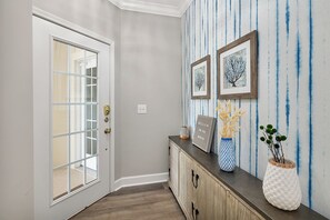 The condo opens up into this foyer, and turns to the right for privacy. 