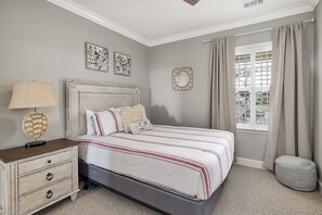 The first bedroom features a queen bed, natural light & plenty of storage. 