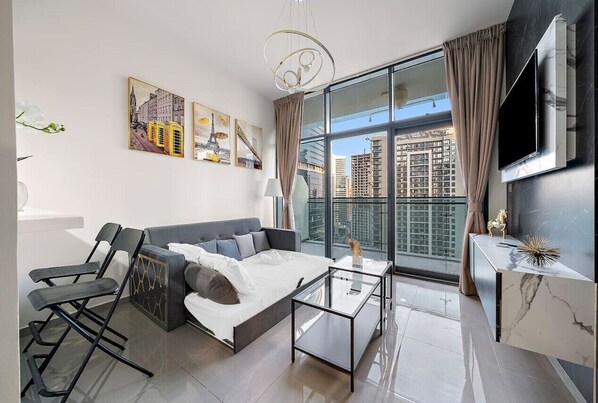 Living Room: Embrace the skyline views in this stylish haven with chic decor and modern comforts!