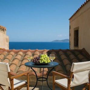 Relax with a glass of wine overlooking the Aegean Sea.