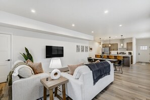 Beautiful open-concept layout, featuring a spacious living room, fully equipped kitchen, and dining area.