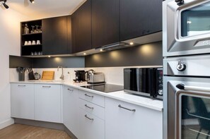 Fully equipped kitchen with amenities such as a dishwasher, Nespresso machine, and induction hob