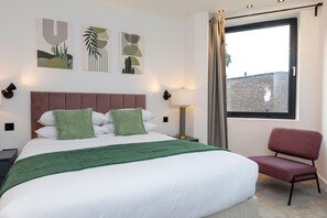 Bedroom with King size bed 200 x 150 cm, wardrobe and armchair.
