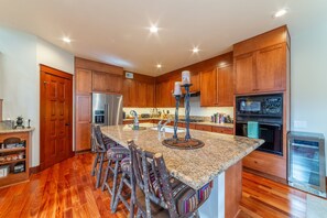 Gorgeous chef's kitchen with large, solid granite, island.