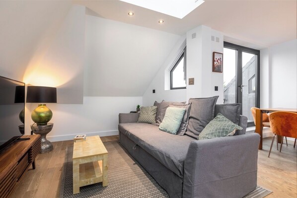 Open-plan living and kitchen area with access to three balconies