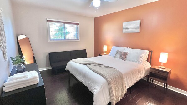 Cozy queen size memory foam bed for a restful night's rest. Adjacent futon can also be folded out into a bed. Room also features a full length mirror and dresser.