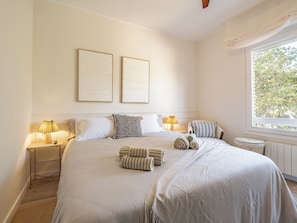 Cama doble con sábanas, almohadas y fundas nórdicas.