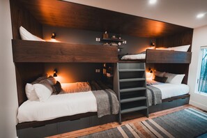 the custom 4-bed bunkroom features queen-size beds on the bottom and full-size beds on top.