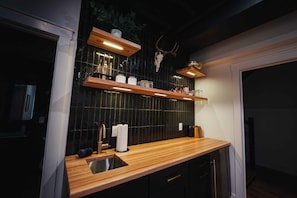 the kitchenette in the basement living room with a mini-fridge.