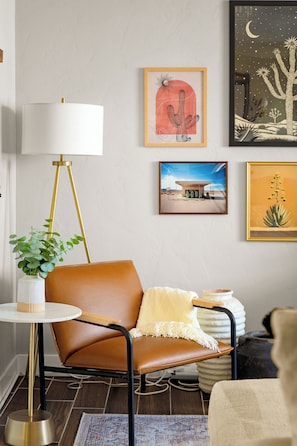 Relax and read a book in the living room while admiring the desert gallery wall.