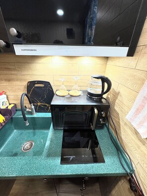 Modern kitchen with appliances – perfect for cooking or brewing coffee.