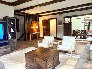 Family room opens to the more formal dining room and staircases up & down.
