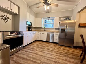 Stove/oven, fridge, dishwasher, microwave, and plenty of cookware.