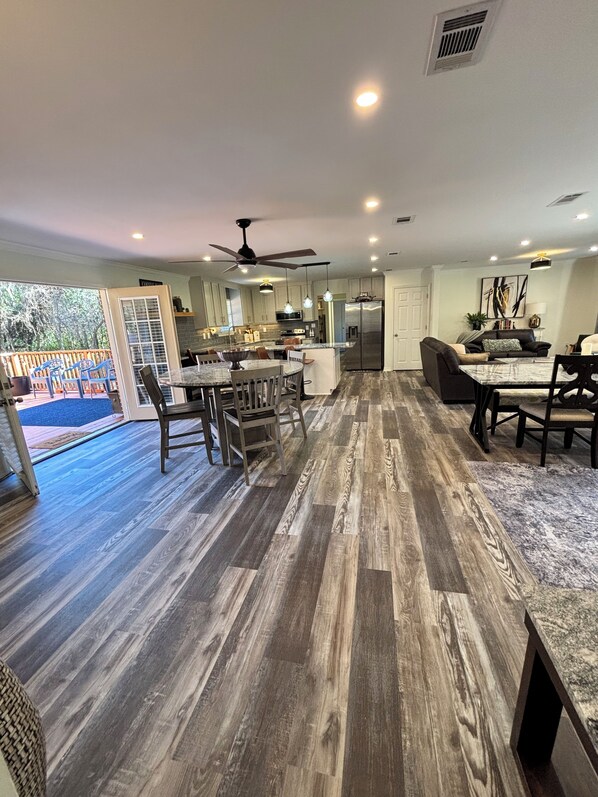 Spacious entertainment space with a modern open floor plan  & deck