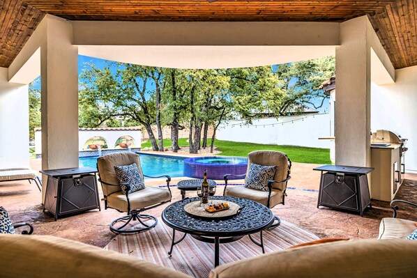 "Poolside bliss! 🏊‍♂️ Escape the heat in our lovely covered patio, where comfort meets stunning views. Perfect for morning coffee or evening cocktails!"