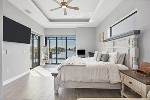 Primary bedroom with king bed, en suite, lanai access, and 65-inch Smart TV
