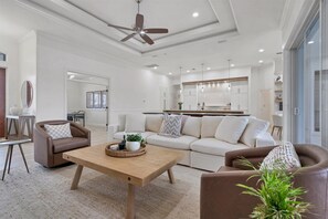 Beautiful open living area with ample seating, 65-inch Smart TV &amp; dining table that converts to a tavern shuffleboard table