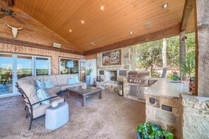 Patio over looking river.  TV, fireplace, bbq grill, mini-frig and more.