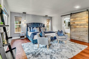 Bedroom 1: Master bedroom, king bed, 3 chairs, gas fireplace, 42” Smart TV, walk-in closet, access to the outdoor deck, en-suite bathroom, lower floor