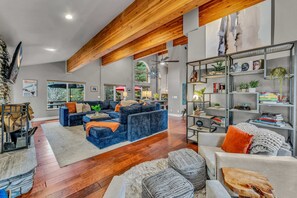 Living Room: Large sectional couch, 2 chairs, Smart TV, wood-burning fireplace, open-layout