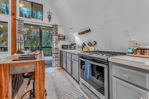Kitchen: Well-equipped kitchen, drip coffee maker, 2 bar stools, open layout to living room 
