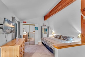 Bedroom 1: King bed, 32” Smart TV, dresser, dedicated workspace, loft, upper floor
