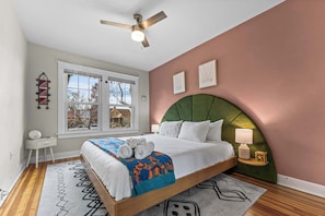 Enjoy the fun headboard and bright paint in this bedroom.