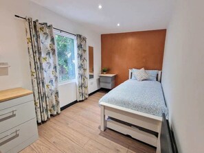 Relax and recharge in this peaceful bedroom with plenty of space and natural light.