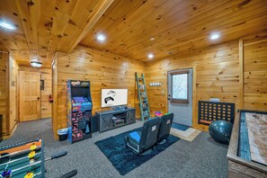 Entertainment haven, with foosball, shuffleboard, arcade, and gaming system in the Game Room