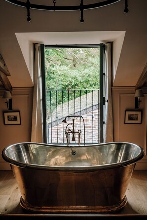 The Master Bedroom Copper Bath and Juliet Balcony. Photo credit: Amy Heycock