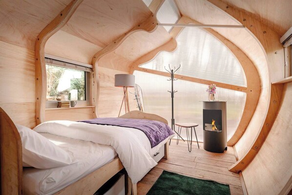 Bedroom with Window View Bright, cosy bedroom with a view outside, highlighting the natural light and modern touches - we provide eye masks. 