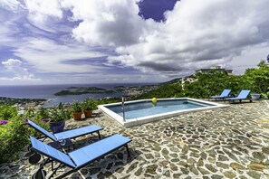 The pool deck with 4 sun loungers and an incredible view!
