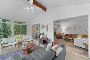 A spacious living room perfect for unwinding after a day of exploring the woods. With plenty of natural light, it’s a serene spot for relaxation.