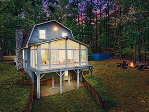 As the sun sets, this peaceful retreat offers a stunning view of the surrounding woods. A perfect place to relax and enjoy quiet moments by the firepit.