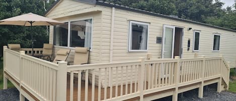 Wrap-around decking with dining furniture.