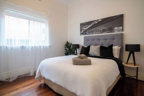 Relax in a cozy bedroom with a plush bed, soft linens, and a calming ambiance, perfect for restful nights.