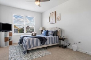 Relax in the cozy queen bed, complete with a ceiling fan and Roku TV—your comfort zone awaits!
