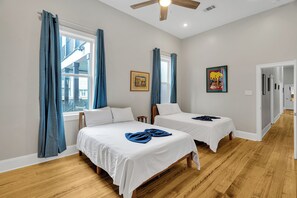 Bright and airy twin room with local artwork and vibrant touches! Perfect for families or friends, this room offers plenty of space to unwind after a day in the city. The charming decor and cozy setup promise a restful stay with a touch of New Orleans flair.