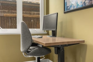 Dedicated workspace with monitor, keyboard and adjustable table and chair