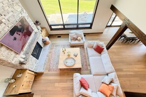 Kick back and relax in the living room, taking advantage of the inviting seating, an enormous TV, and a cozy gas fireplace.