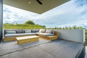 The spacious outdoor cover lounge area features comfortable seating and is just steps from the pool