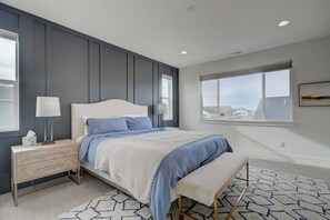 Relax in our bedroom's king-sized bed with soft bedding, perfect for recharging after a day out.
