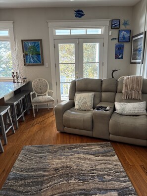 Kitchen and adjoining living room with ample seating and view of Spa Creek.