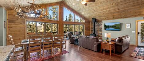 Open concept living room with floor to ceiling windows