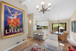 A lively, art-filled space that seamlessly connects the kitchen and dining area, perfect for hosting friends or enjoying a quiet meal